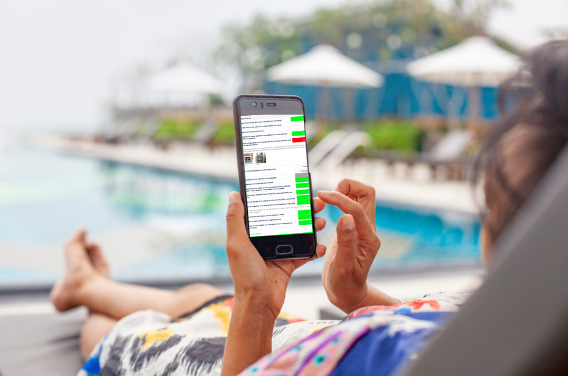 Woman relaxing by the pool and checking the status of her home check.