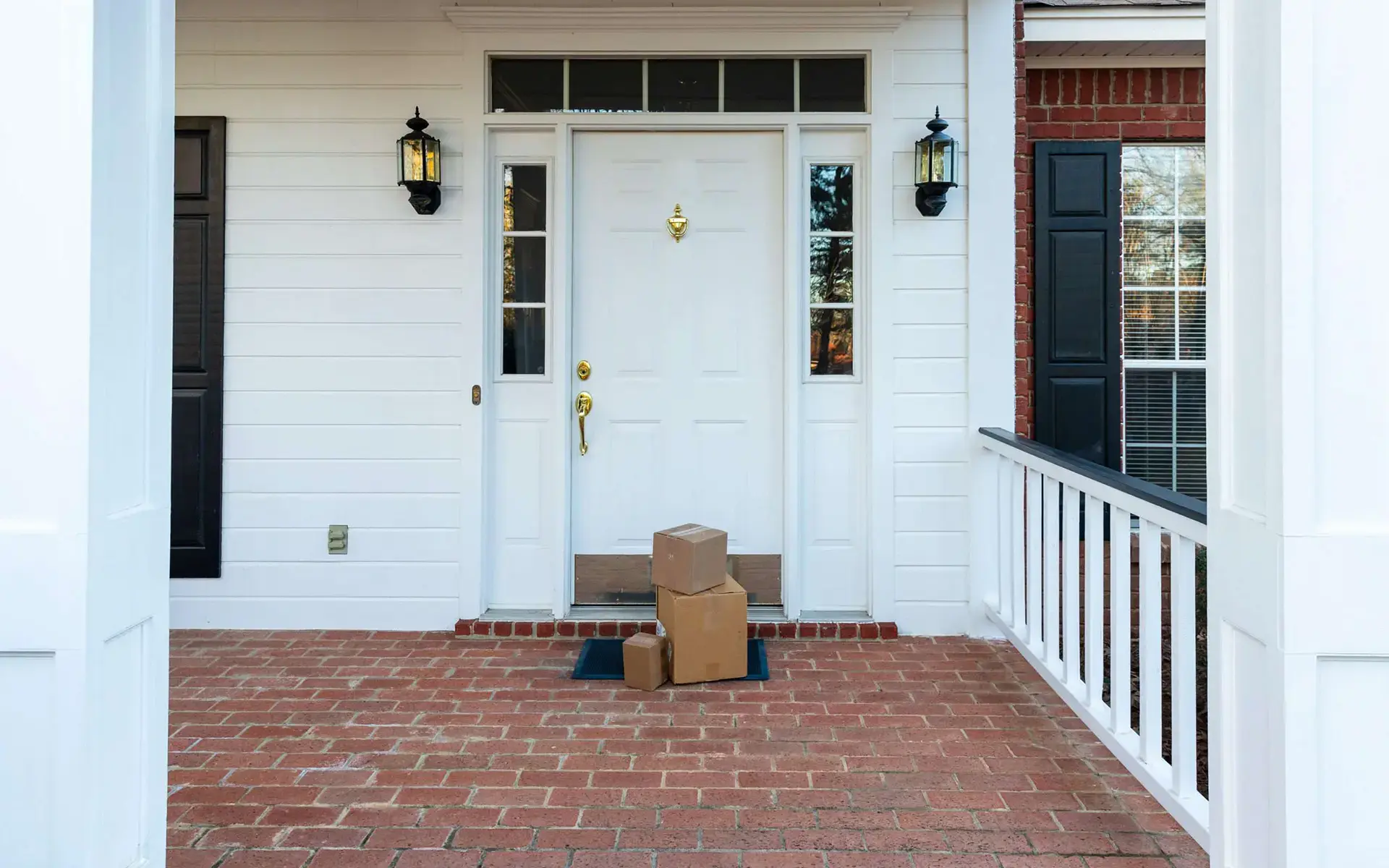 mail and packages wait on a front step to get picked up and brought inside